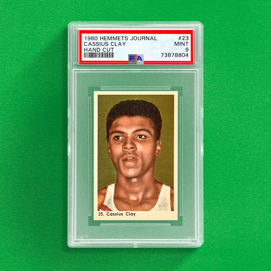PSA slab of a 1960 Hemmets Journal #23 Cassius Clay card labelled Hand Cut, Mint 9