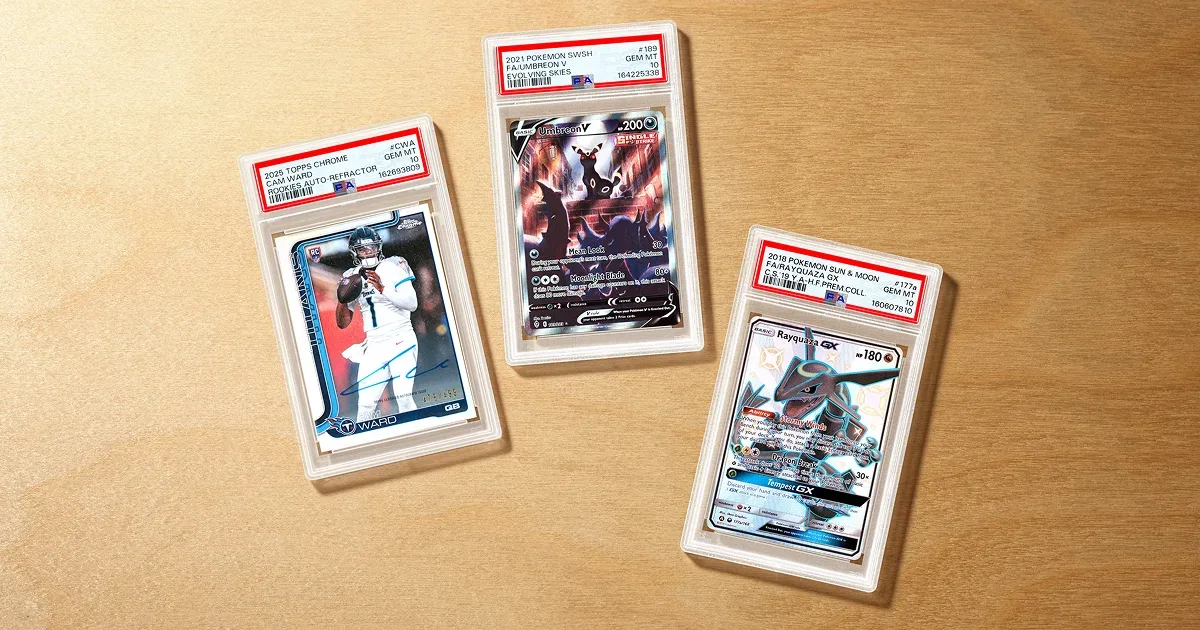 Three PSA 10 slabs on a wooden table, a 2025 Topps Chrome Cam Ward rookie auto refractor, an Umbreon V and a Rayquaza GX
